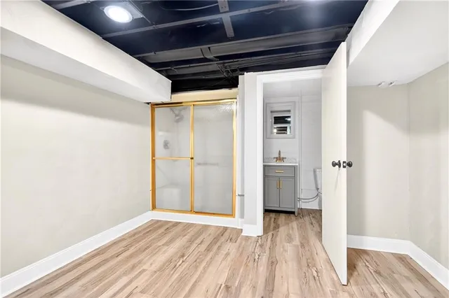 a view of empty room with wooden floor