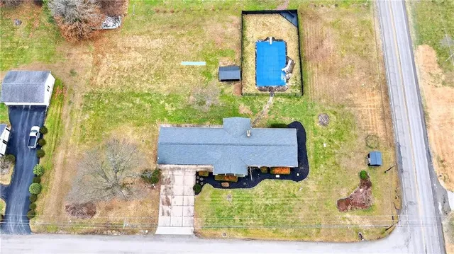 an aerial view of a house with a swimming pool
