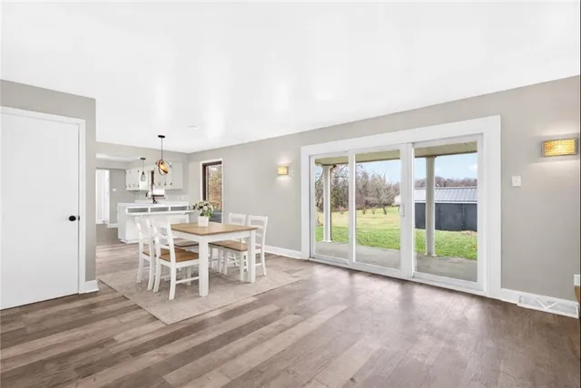 a dining room with furniture wooden floor and a rug