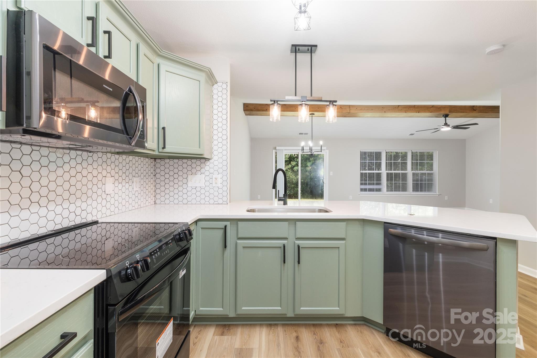 181 Mott Road Mooresville, NC 28115 - Photo 11 of 26 a kitchen with a sink stove and microwave