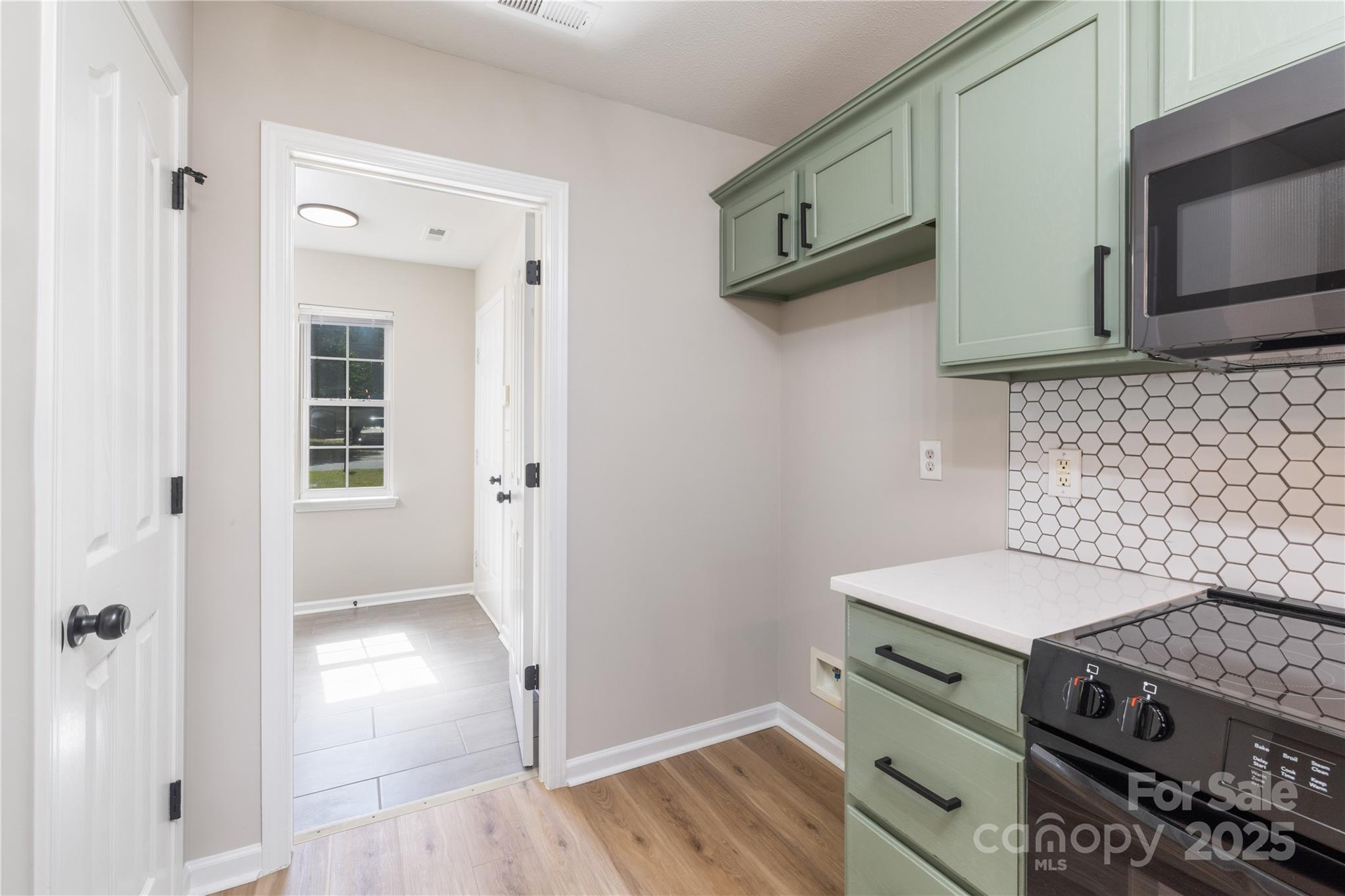 181 Mott Road Mooresville, NC 28115 - Photo 12 of 26 a kitchen with granite countertop a stove and a microwave