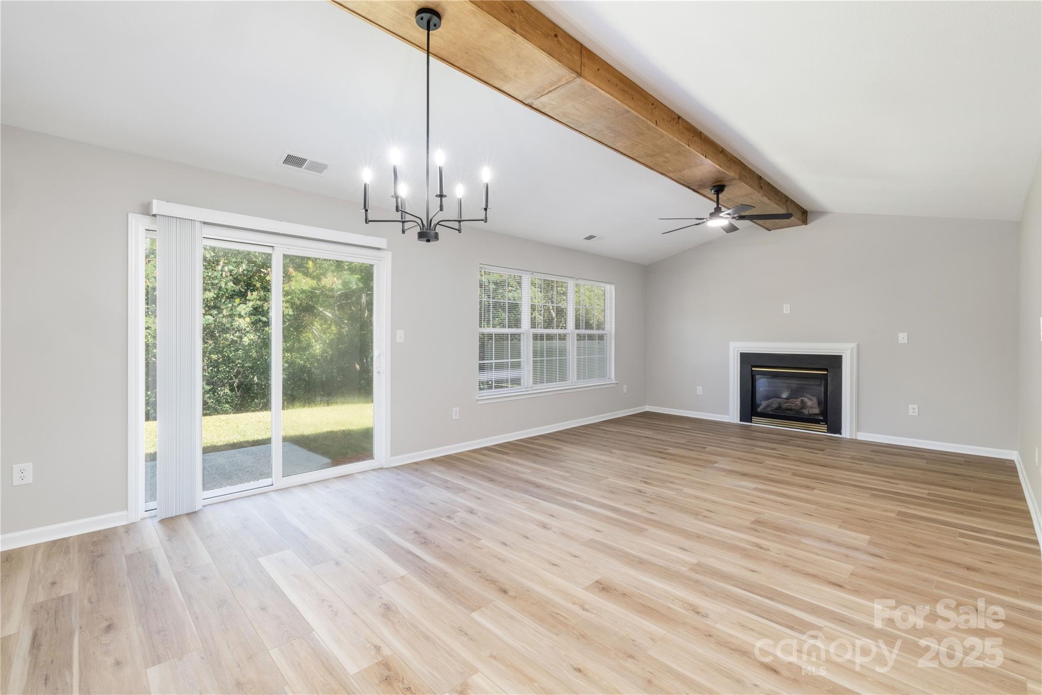 181 Mott Road Mooresville, NC 28115 - Photo 13 of 26 a view of an empty room with wooden floor and a window