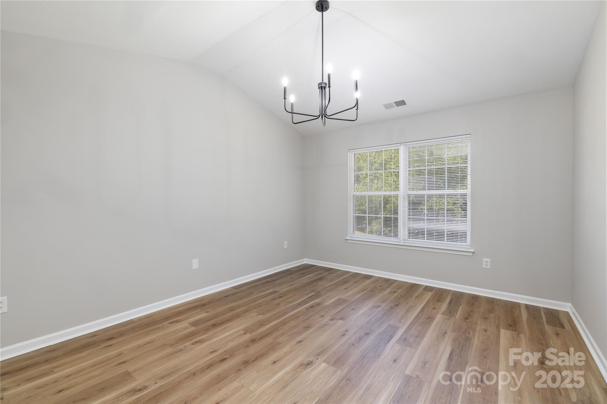 181 Mott Road Mooresville, NC 28115 - Photo 17 of 26 a view of an empty room with wooden floor and a window