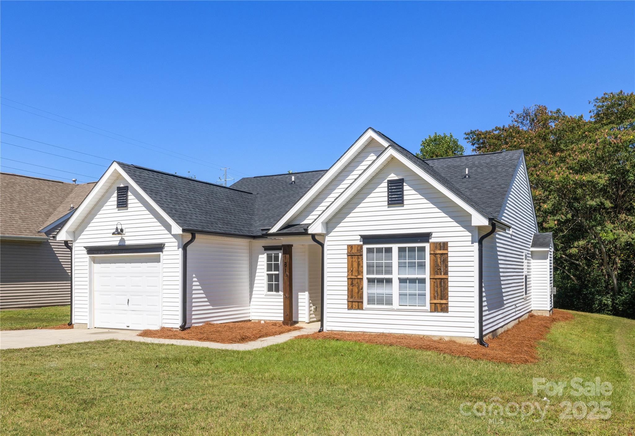 181 Mott Road Mooresville, NC 28115 - Photo 3 of 26 a front view of a house with a yard and garage