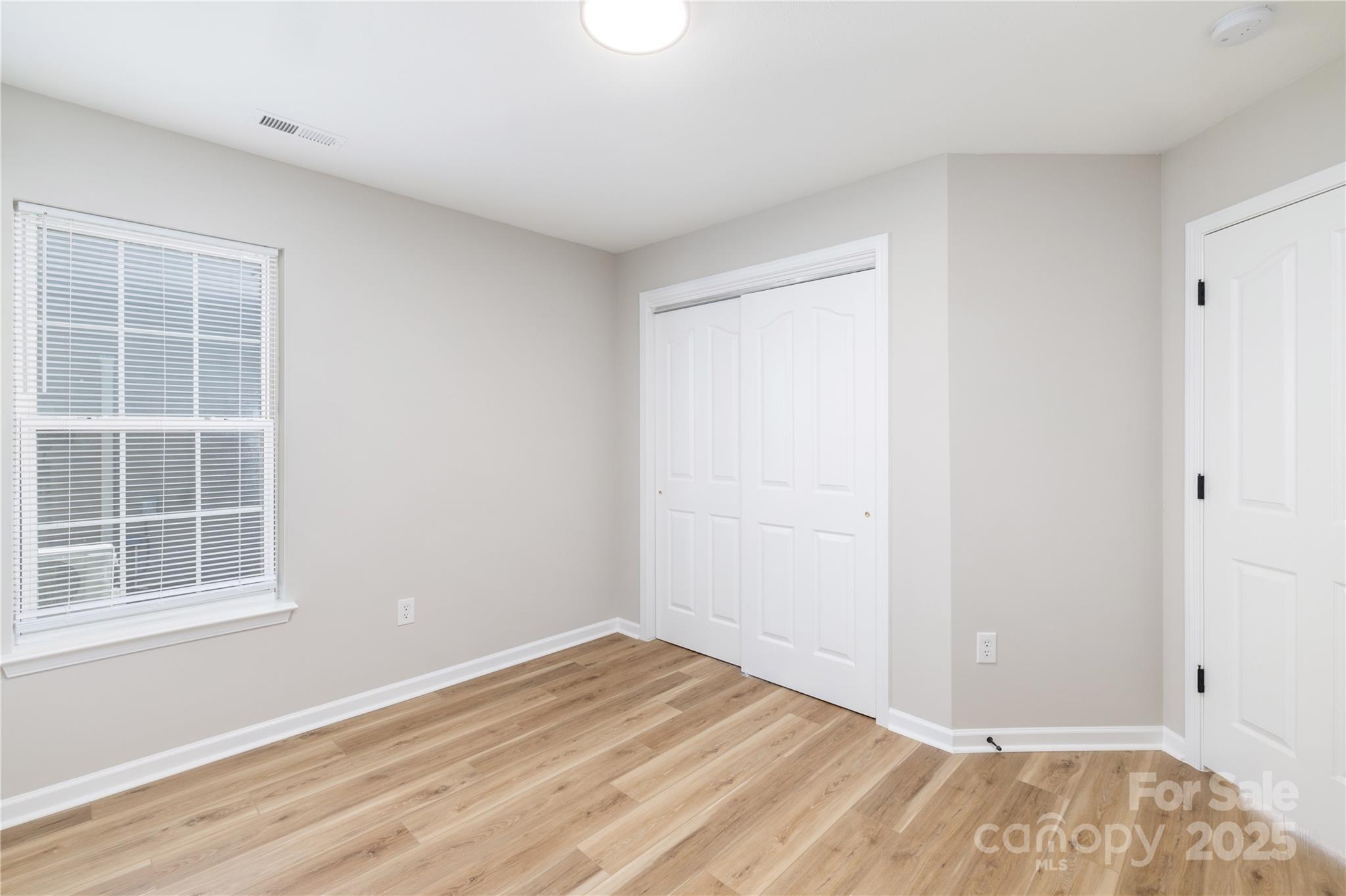 181 Mott Road Mooresville, NC 28115 - Photo 6 of 26 a view of empty room with wooden floor and fan
