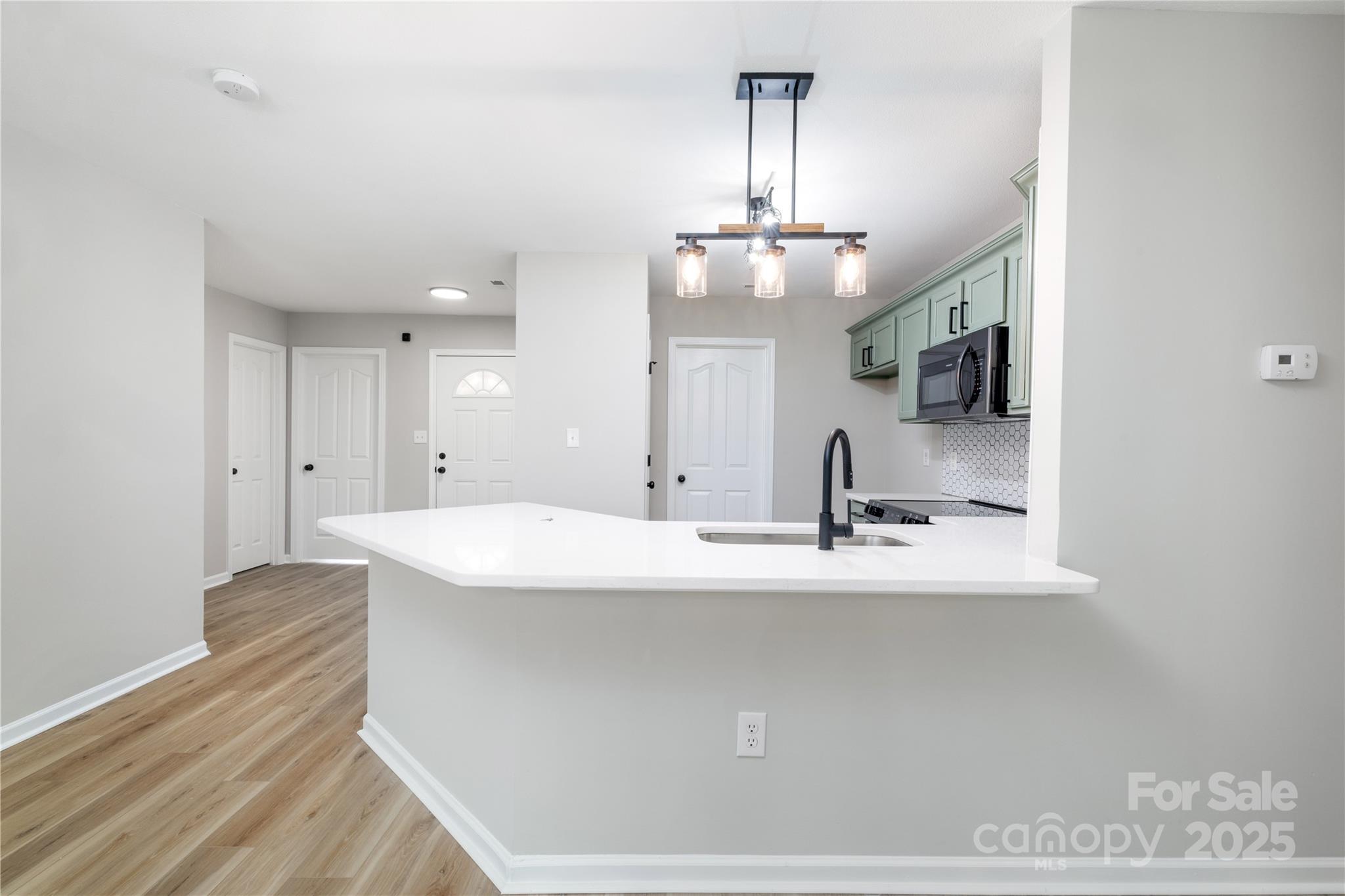 181 Mott Road Mooresville, NC 28115 - Photo 9 of 26 a view of a kitchen counter space a sink and wooden floor