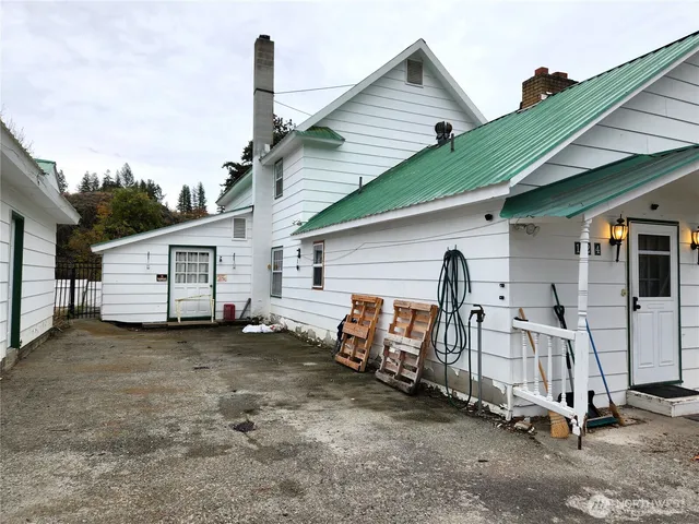 a view of a house with a yard and furniture
