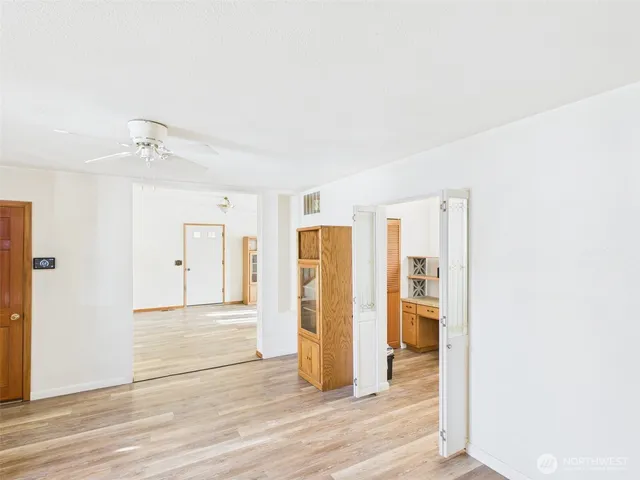 an empty room with wooden floor and closet