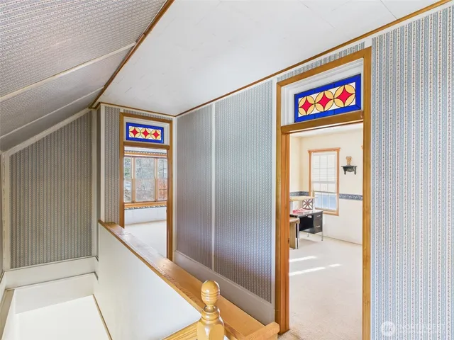 a view of a hallway with wooden floor