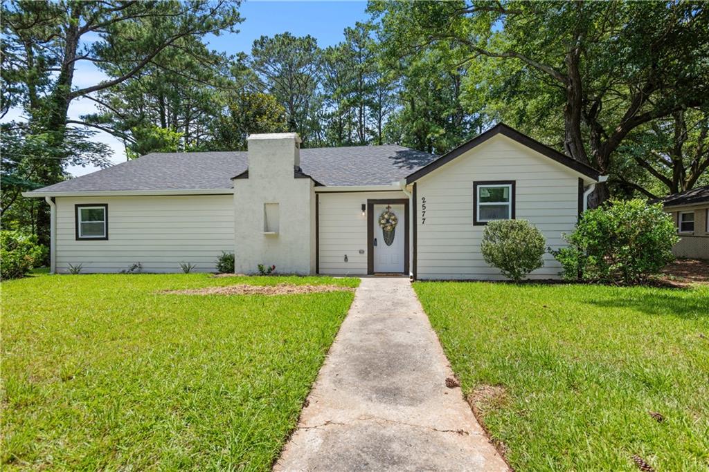 2577 Barge Road Southwest Atlanta, GA 30331 - Photo 1 of 1 a front view of house with yard and green space