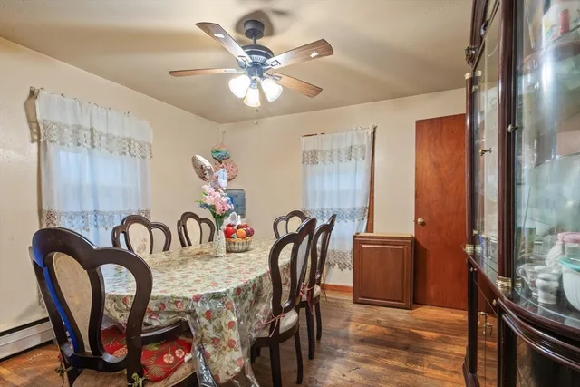 a dining room with furniture a chandelier and wooden floor