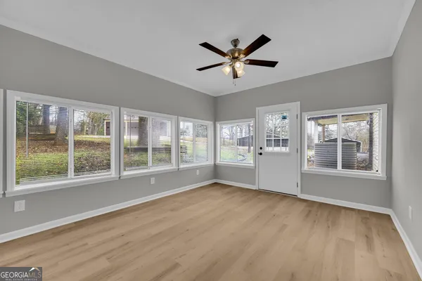 a view of a house with a small yard and wooden fence