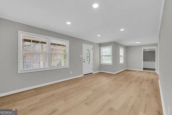 a kitchen with stainless steel appliances granite countertop a stove top oven a sink and white cabinets