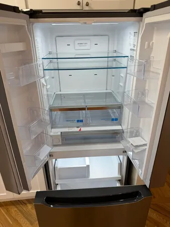 walk in closet with wooden floor washer and dryer