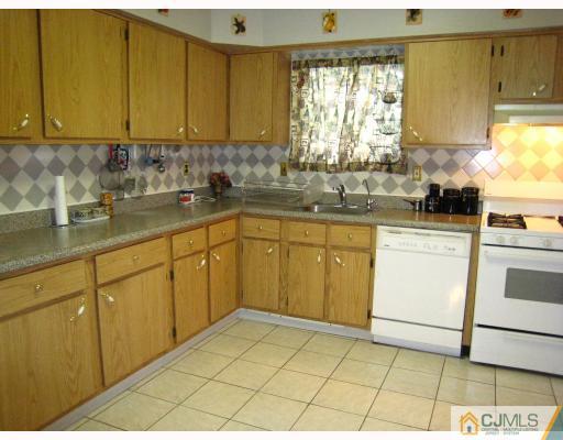5207 Hana Road Edison, NJ 08817 - Photo 4 of 10 a kitchen with a sink window and cabinets