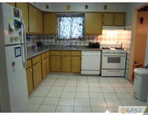 5207 Hana Road Edison, NJ 08817 - Photo 5 of 10 a kitchen with a sink a stove and a refrigerator
