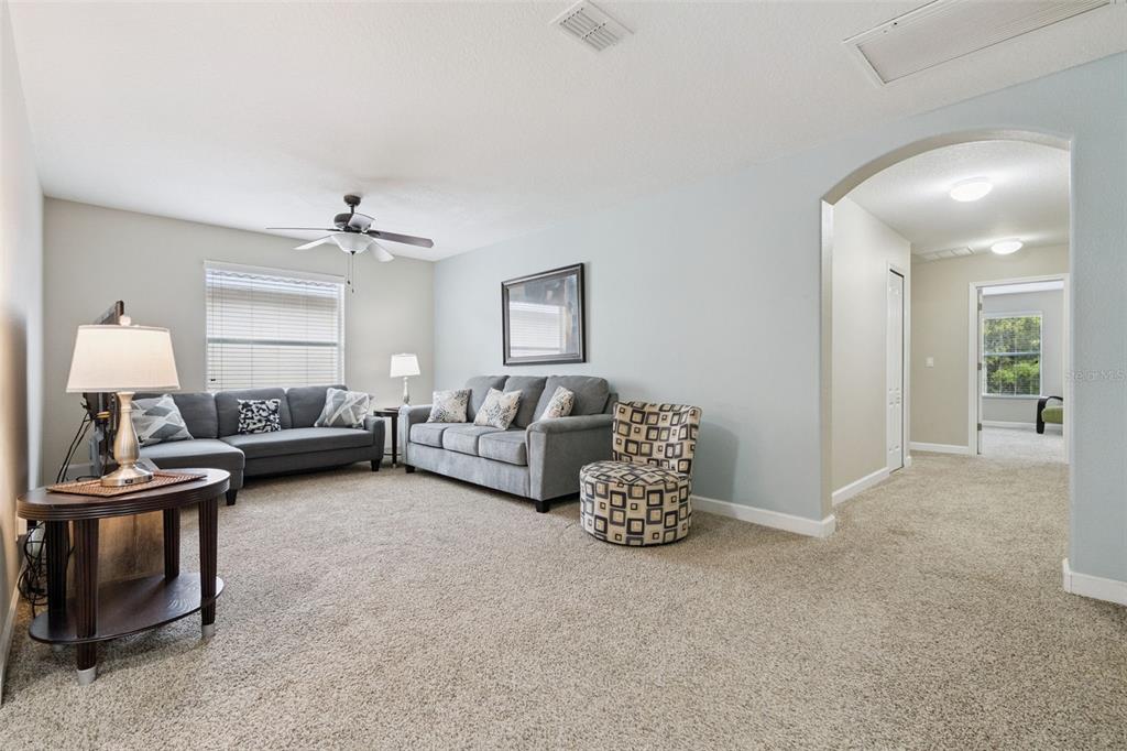 8965 Cuban Palm Road Kissimmee, FL 34747 - Photo 14 of 77 a living room with furniture and a lamp