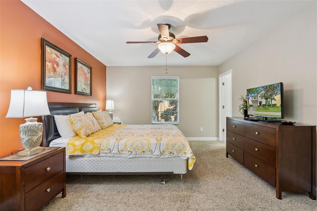 8965 Cuban Palm Road Kissimmee, FL 34747 - Photo 16 of 77 a bedroom with a bed and a dresser