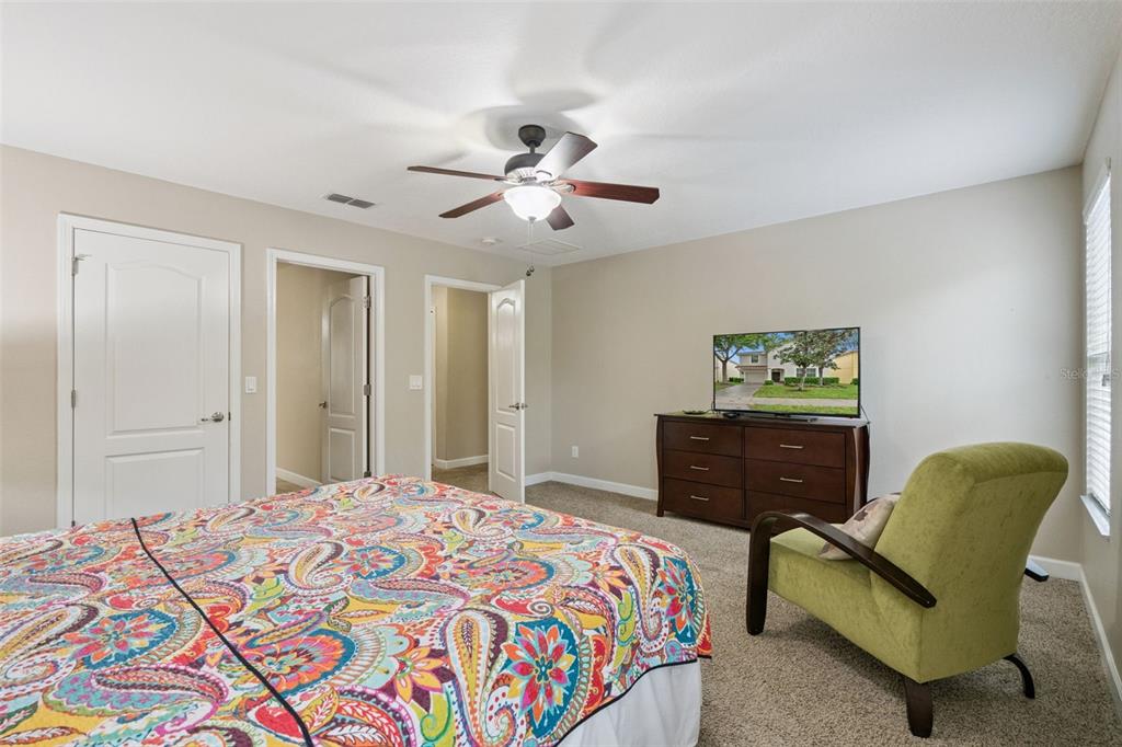 8965 Cuban Palm Road Kissimmee, FL 34747 - Photo 19 of 77 a bedroom with a bed and a dresser with wooden floor