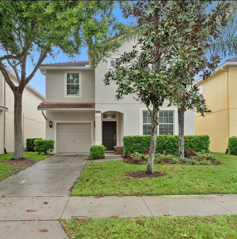 8965 Cuban Palm Road Kissimmee, FL 34747 - Photo 2 of 77 a front view of a house with garden