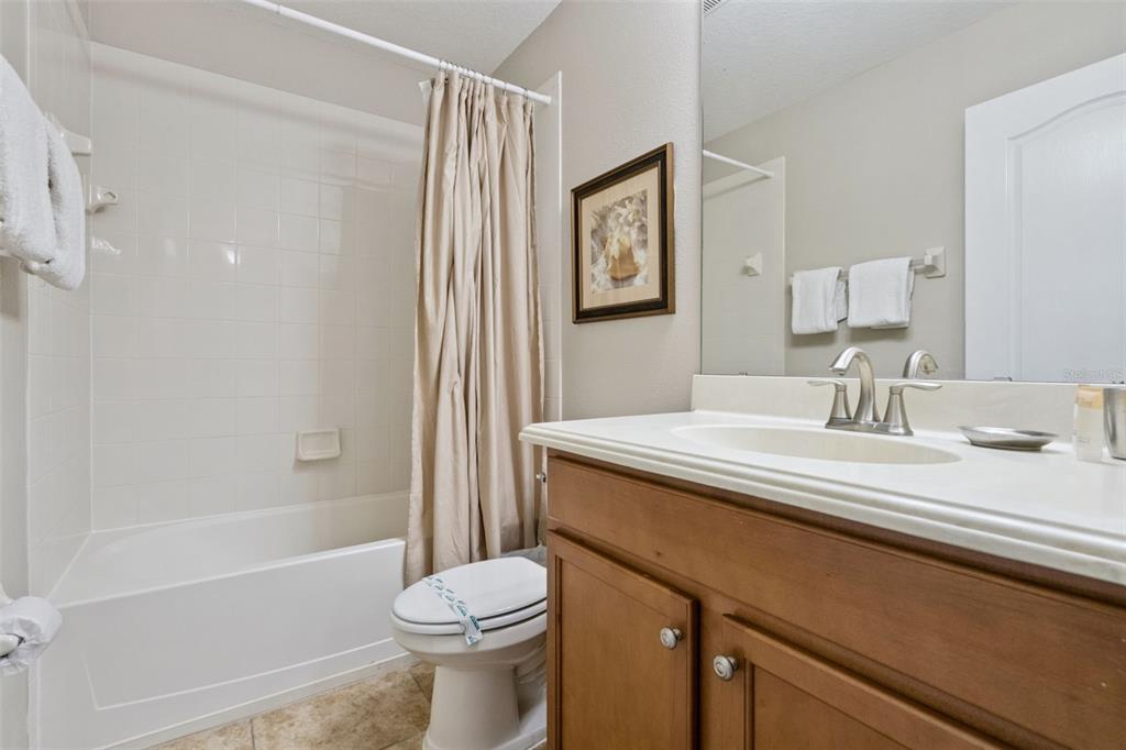 8965 Cuban Palm Road Kissimmee, FL 34747 - Photo 26 of 77 a bathroom with a sink a toilet and shower