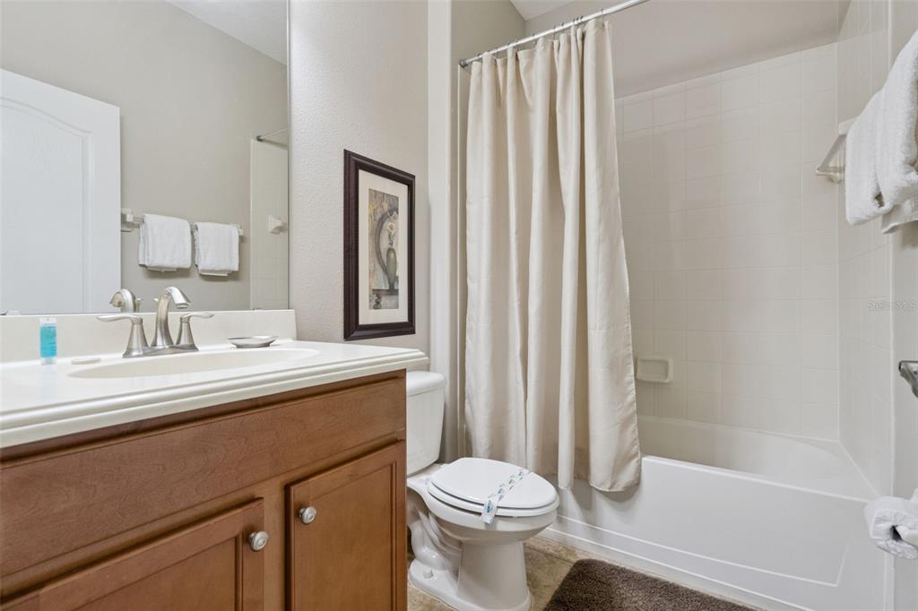 8965 Cuban Palm Road Kissimmee, FL 34747 - Photo 27 of 77 a bathroom with a sink a toilet and shower