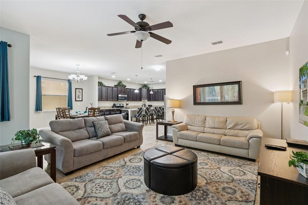 8965 Cuban Palm Road Kissimmee, FL 34747 - Photo 5 of 77 a living room with furniture ceiling fan and a rug