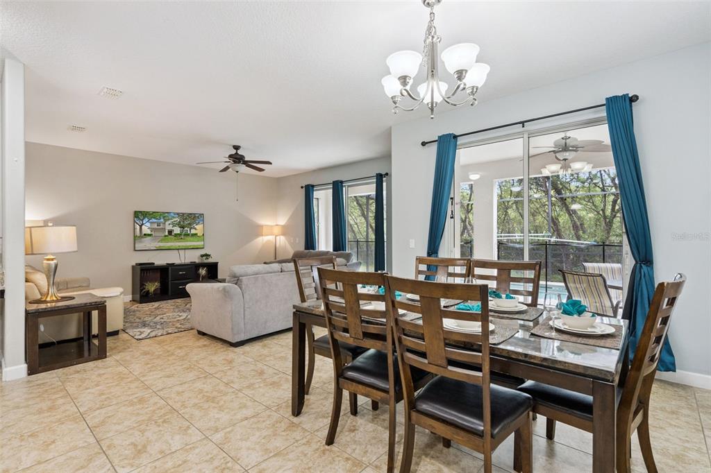 8965 Cuban Palm Road Kissimmee, FL 34747 - Photo 8 of 77 a view of a dining room with furniture wooden floor and chandelier