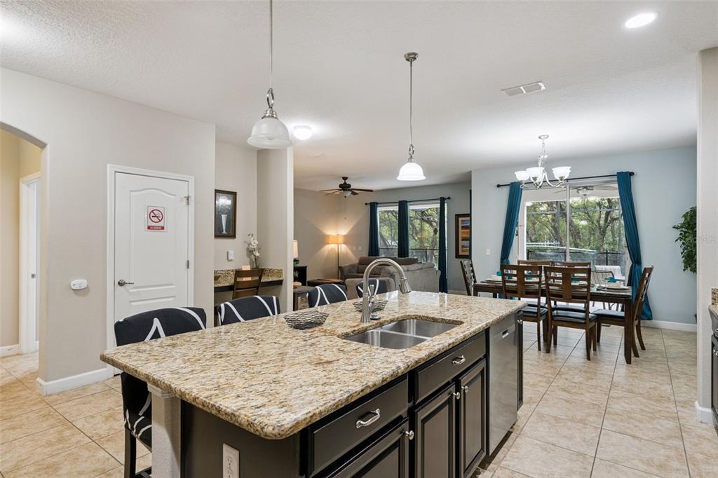 8965 Cuban Palm Road Kissimmee, FL 34747 - Photo 9 of 77 a kitchen with center island table and chairs