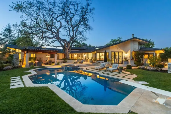 a view of a house with backyard porch and sitting area