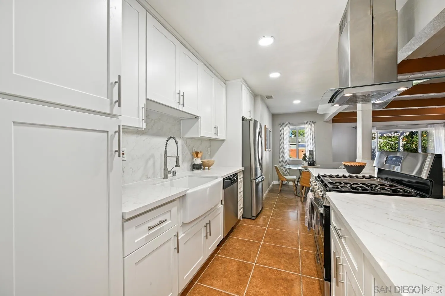 720 Fern Street Escondido, CA 92027 - Photo 11 of 28 a kitchen with a sink stainless steel appliances and white cabinets