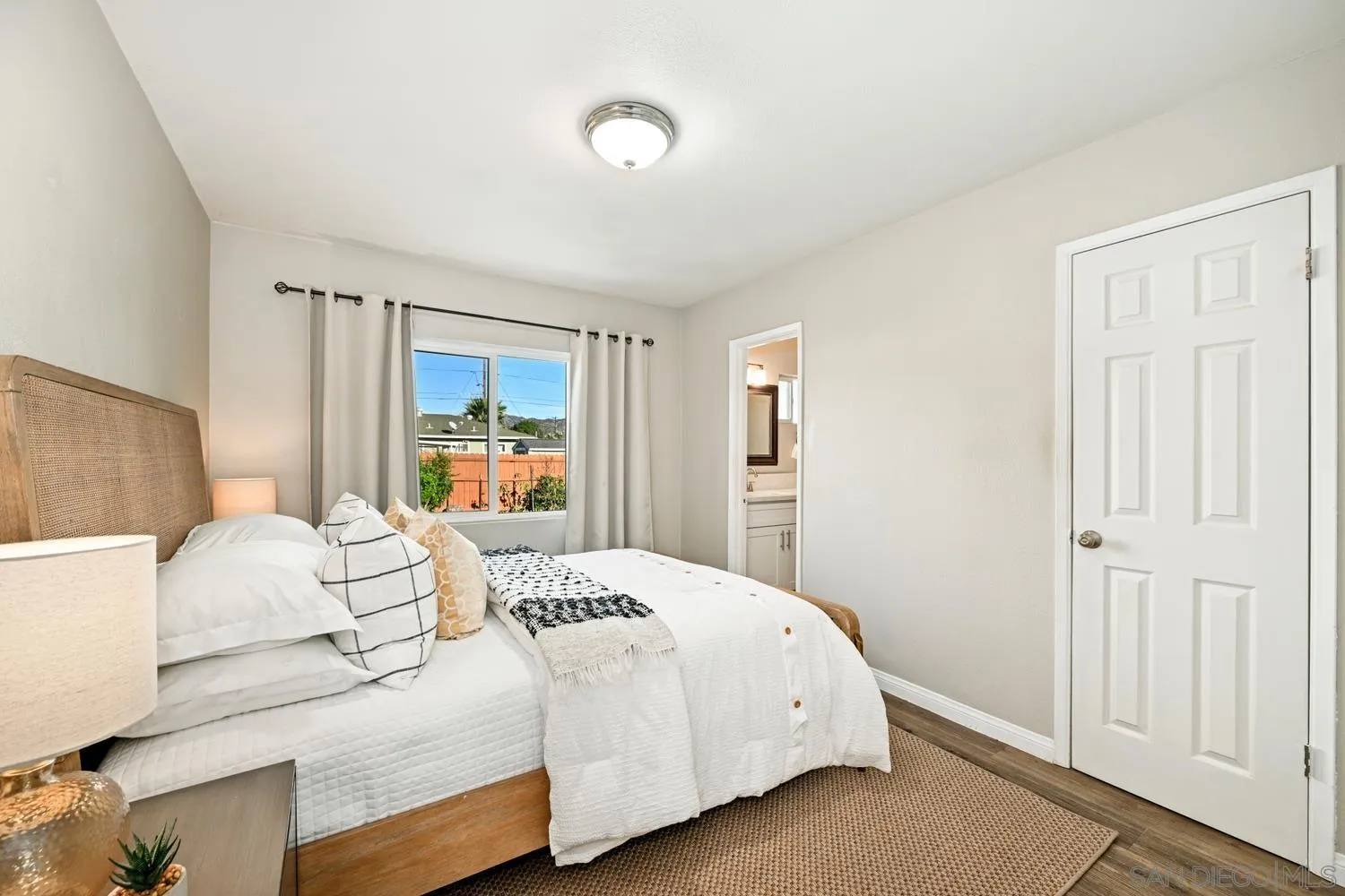 720 Fern Street Escondido, CA 92027 - Photo 14 of 28 a bedroom with a large bed and a window