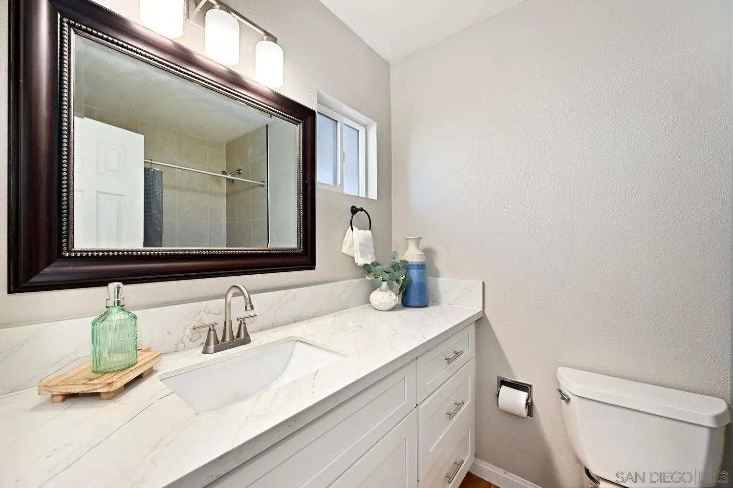 720 Fern Street Escondido, CA 92027 - Photo 16 of 28 a bathroom with a granite countertop toilet sink and a mirror