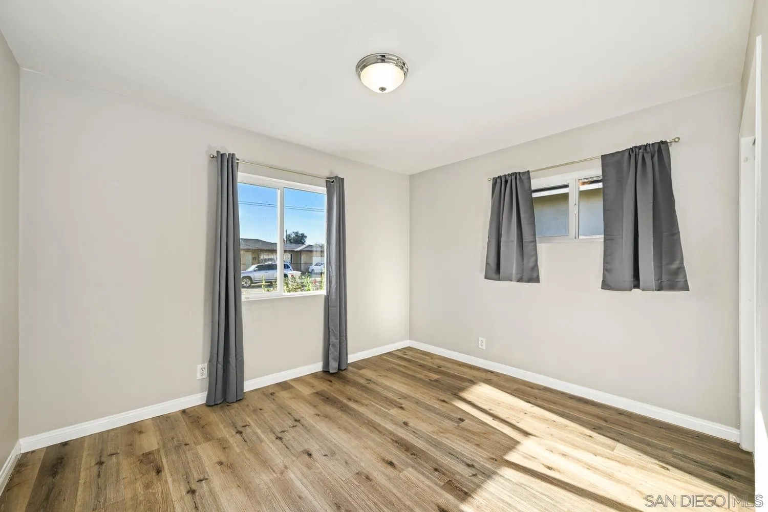 720 Fern Street Escondido, CA 92027 - Photo 17 of 28 a view of empty room with wooden floor and fan