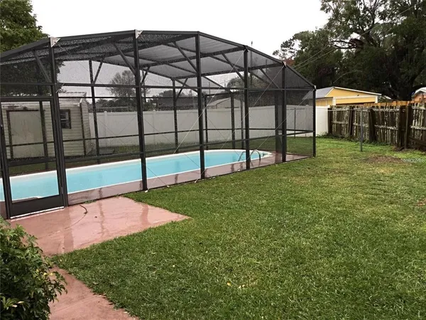 a view of a backyard with a garden and deck