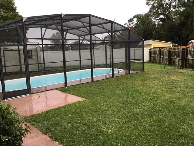 a view of a backyard with a garden and deck