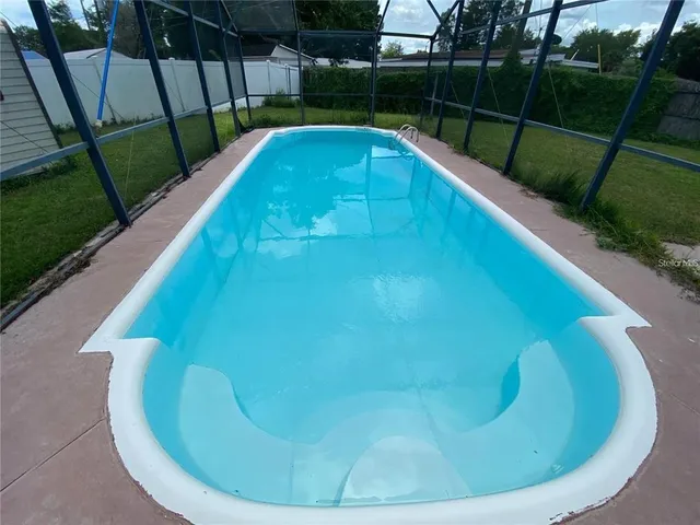 a view of a swimming pool with a sink and wooden floor