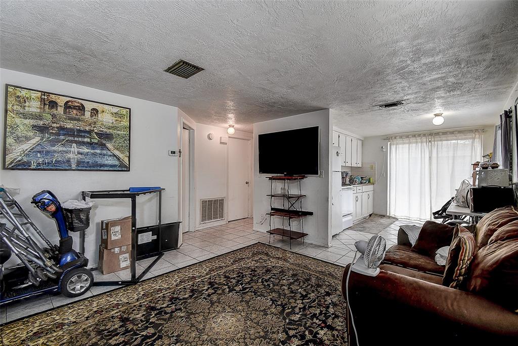 6113 Georgia Avenue New Port Richey, FL 34653 - Photo 1 of 1 a living room with furniture and a flat screen tv