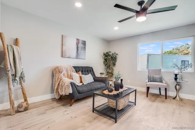 a living room with furniture and a floor to ceiling window