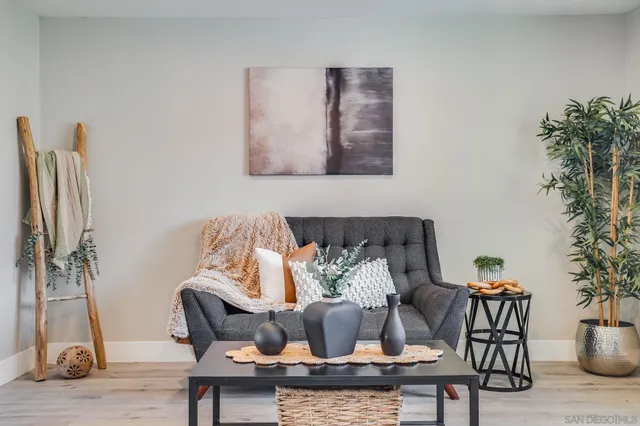 a living room with furniture and a potted plant