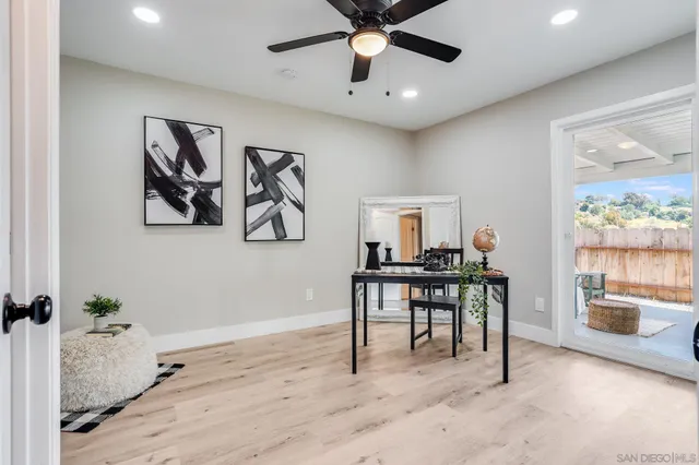 a workspace with wooden floor and windows