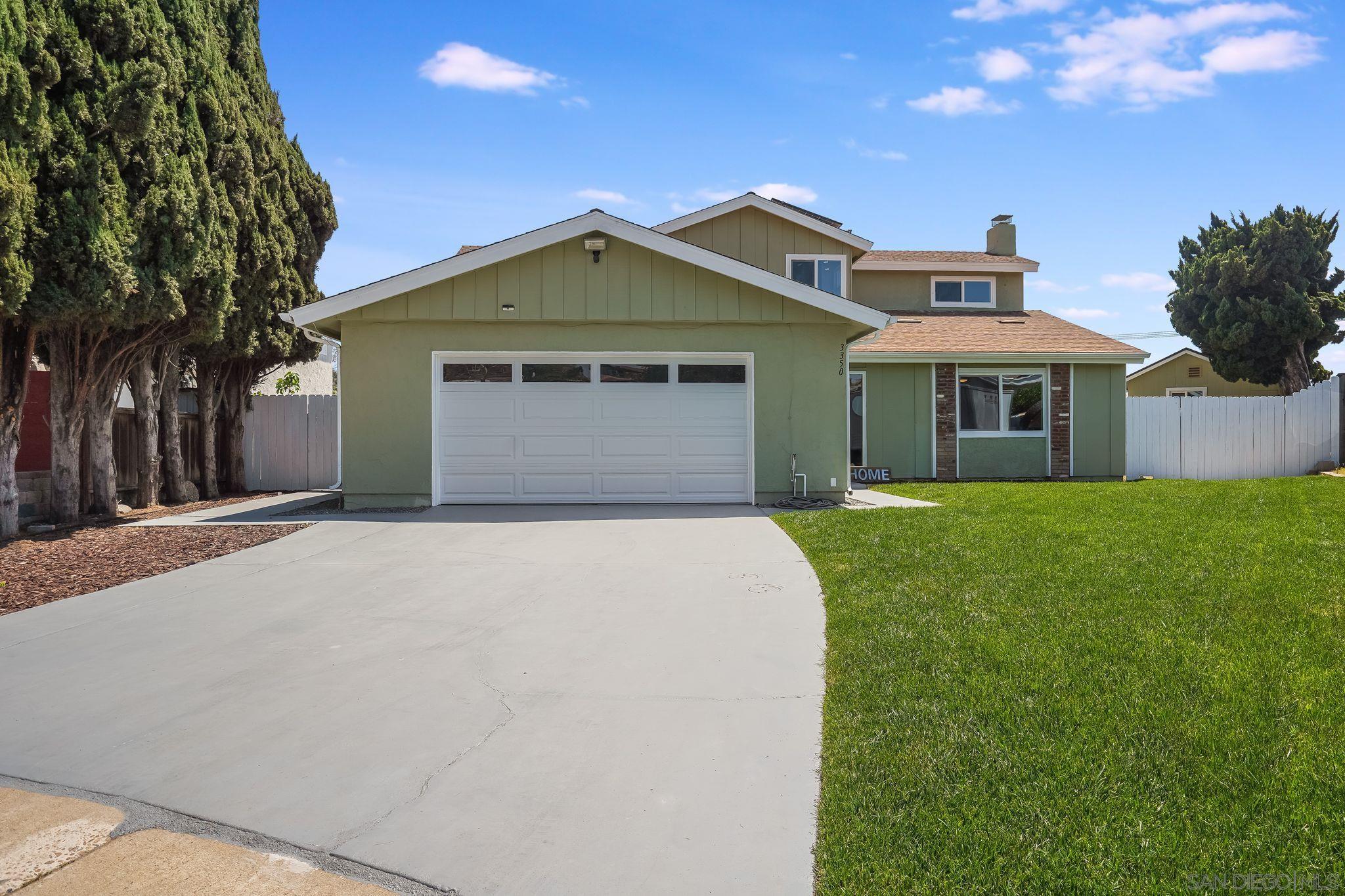 3350 Watercrest Court Bonita, CA 91902 - Photo 3 of 27 a front view of a house with a yard and garage