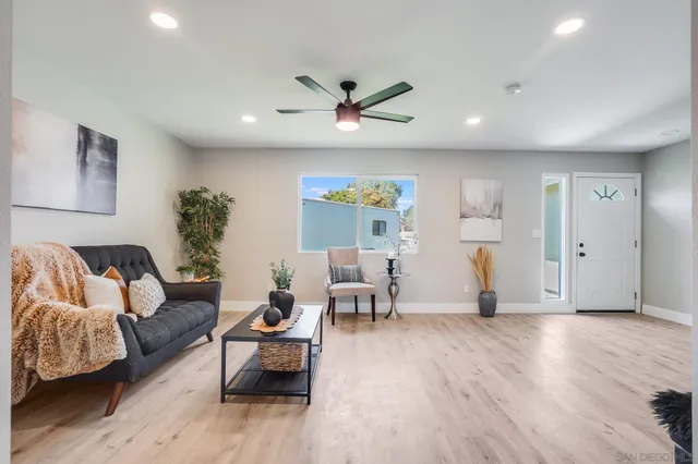 a living room with furniture and a wooden floor
