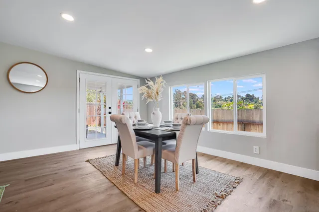 a view of a dining room with furniture window and wooden floor