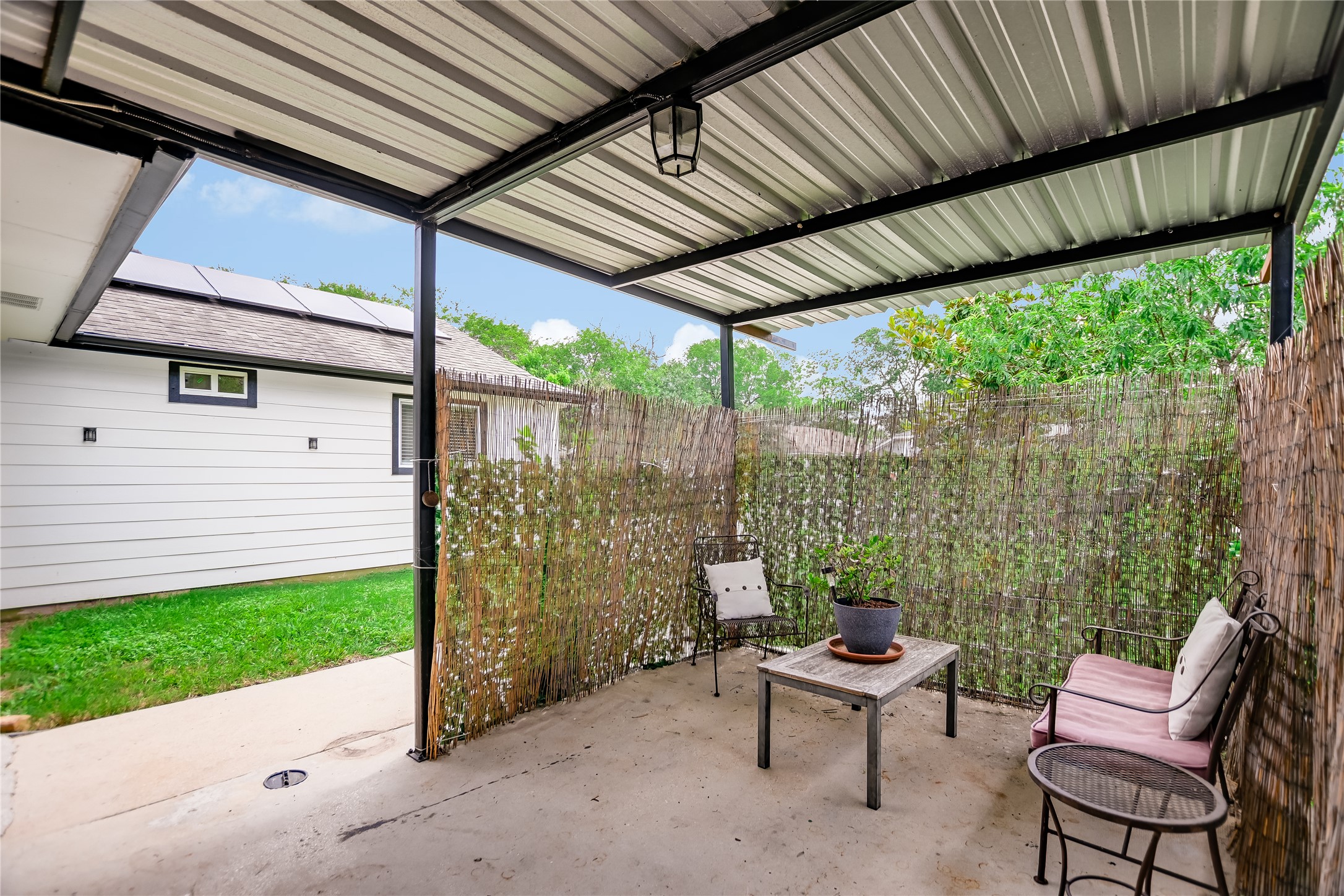 4702 Crest Oak Road Austin, TX 78744 - Photo 15 of 20 Covered patio featuring a corrugated metal roof and concrete flooring