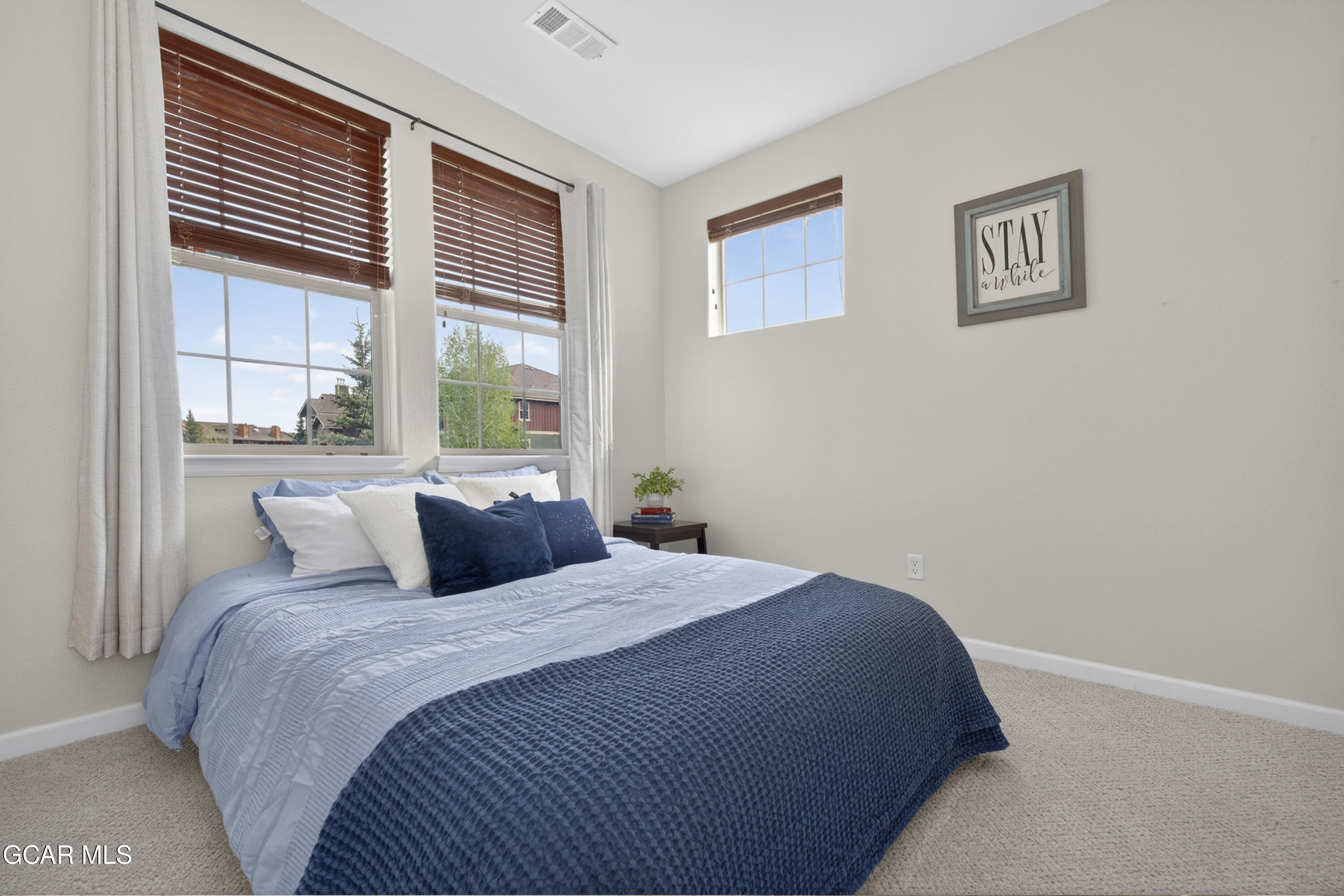 158 Village Road Granby, CO 80446 - Photo 17 of 46 a bedroom with a large bed and a window