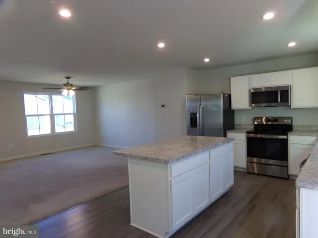 a kitchen with granite countertop a stove and a sink