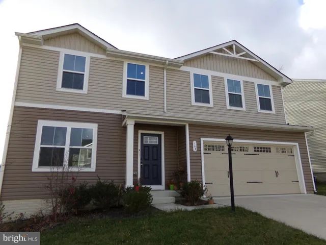 a front view of a house with a yard and porch