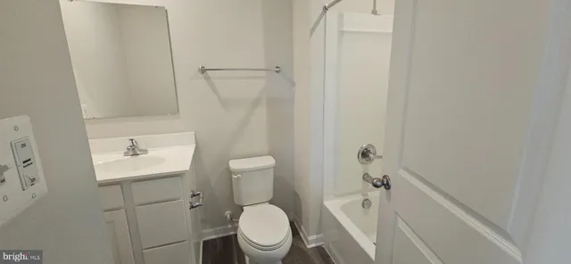 a white toilet sitting next to a bathroom sink