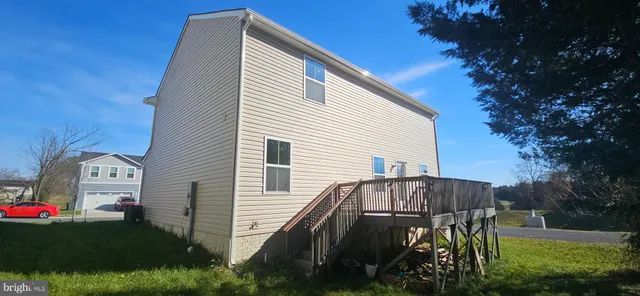 a view of backyard with seating and green space